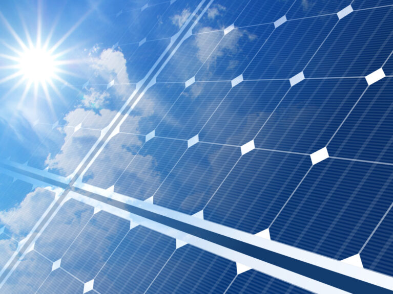 solar panels on blue sky and sun